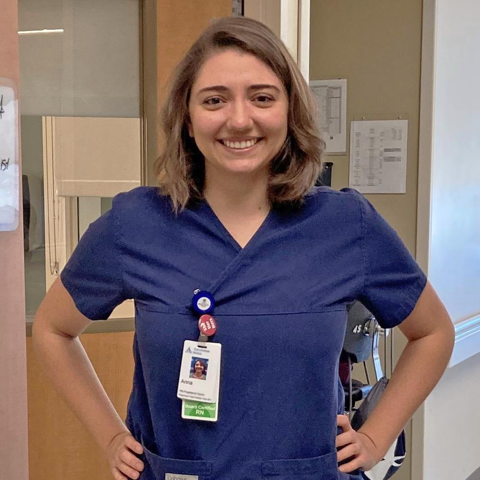 Photo of Annie Steinhauser, MSN, RN, PCCN, standing with her hands on her hips and smiling in a clinical setting. 安妮的照片steinhaus指出,MSN, RN, PCCN替身g with her hands on her hips and smiling in a clinical setting.
