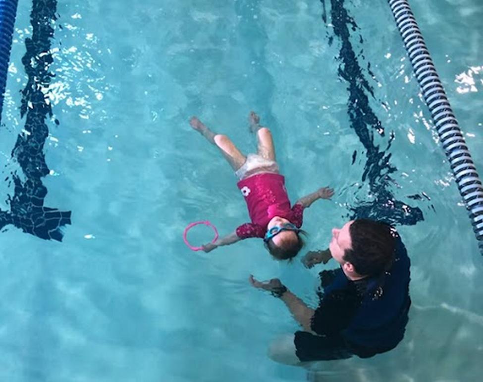 Kimber McCrackin floating on her back when she first started adaptive swim lessons at 2 years old (Photo Courtesy of: Heather McCrackin)