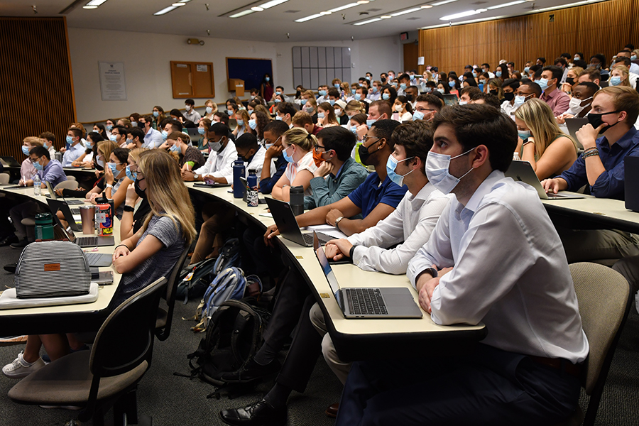 students in the auditorium with masks